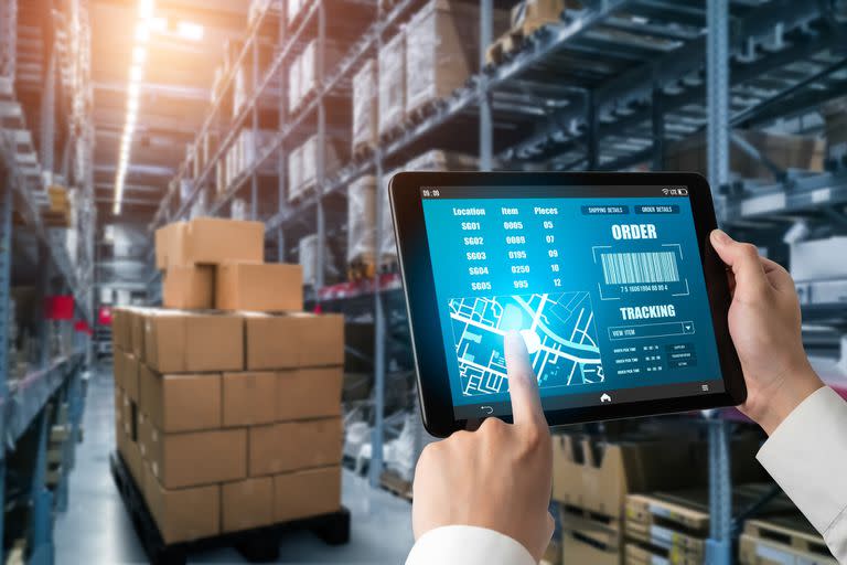 Warehouse management innovative software in computer for real time monitoring of goods package delivery . Computer screen showing smart inventory dashboard for storage and supply chain distribution .