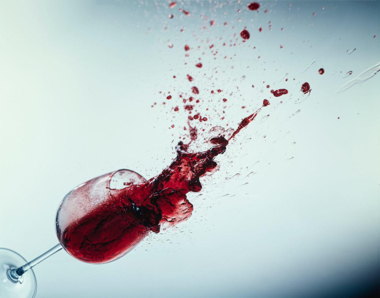 A glass of wine falling as the wine spills out