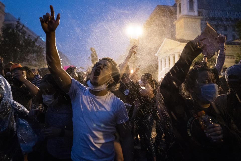 Demonstrators protest, Thursday, June 4, 2020, near the White House in Washington, over the death of George Floyd, a black man who was in police custody in Minneapolis. Floyd died after being restrained by Minneapolis police officers. (AP Photo/Evan Vucci)