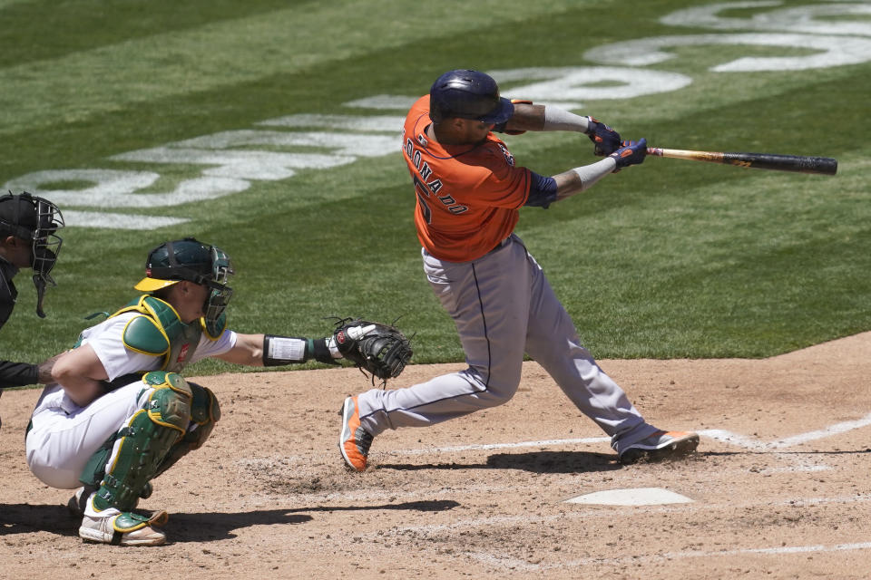 Houston Astros' Martin Maldonado, right, hits a two-run home run in front of Oakland Athletics catcher Sean Murphy during the fourth inning of a baseball game in Oakland, Calif., Thursday, May 20, 2021. (AP Photo/Jeff Chiu)