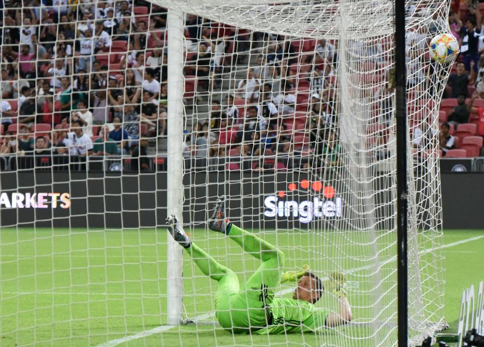 Juventus goalkeeper Wojciech Szczesny falls into the goal net after conceding Harry Kane's goal in their International Champions Cup match against Tottenham at the National Stadium. (PHOTO: Zainal Yahya/Yahoo News Singapore)