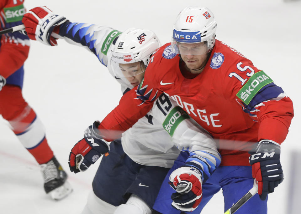 Jason Robertson of the US, left, challenges for the puck with Norway's Tommy Kristiansen during the Ice Hockey World Championship group B match between Norway and United States at the Arena in Riga, Latvia, Saturday, May 29, 2021. (AP Photo/Sergei Grits)