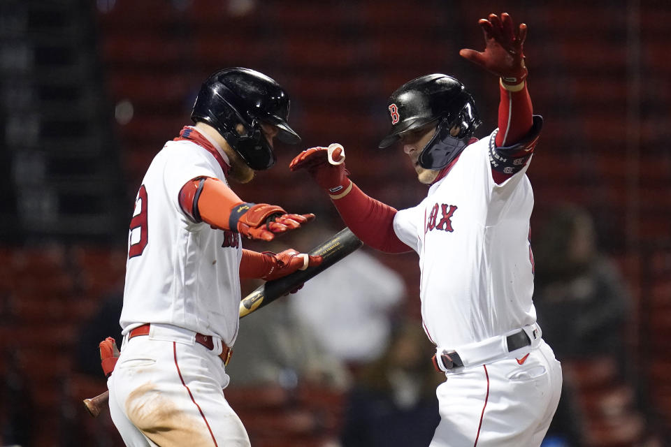 Boston Red Sox's Enrique Hernandez, right, dances with Alex Verdugo after crossing home plate while celebrating his solo home run during the eighth inning of a baseball game against the Detroit Tigers at Fenway Park, Tuesday, May 4, 2021, in Boston. (AP Photo/Charles Krupa)