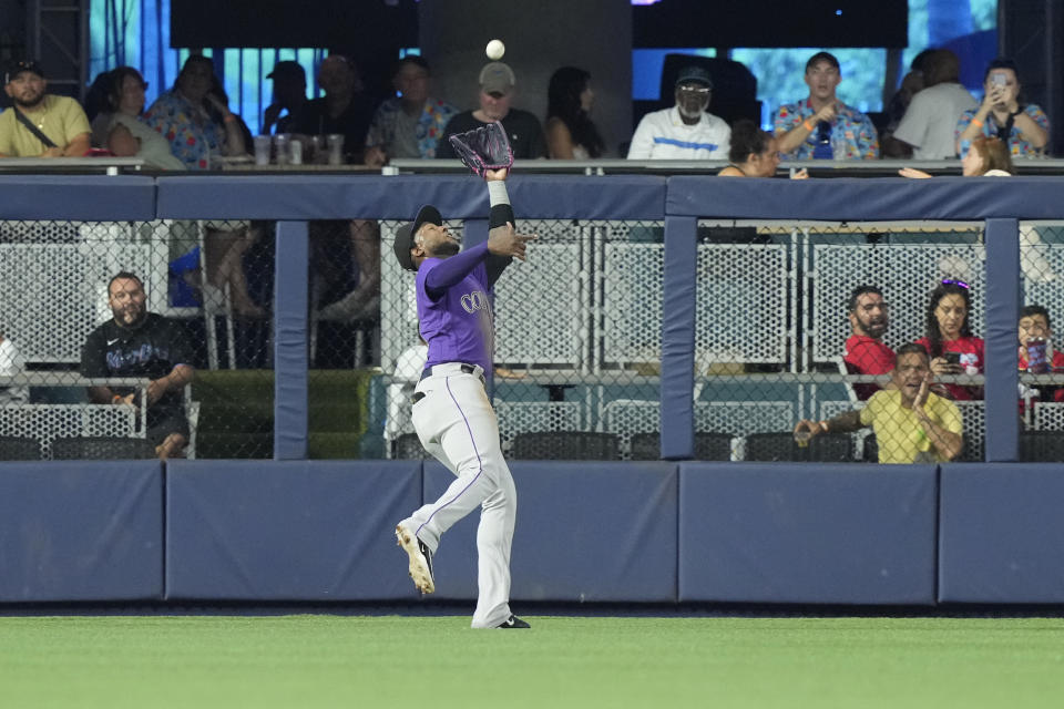 Colorado Rockies left fielder Jurickson Profar catches a hit by Miami Marlins' Luis Arraez during the third inning of a baseball game, Sunday, July 23, 2023, in Miami. (AP Photo/Marta Lavandier)