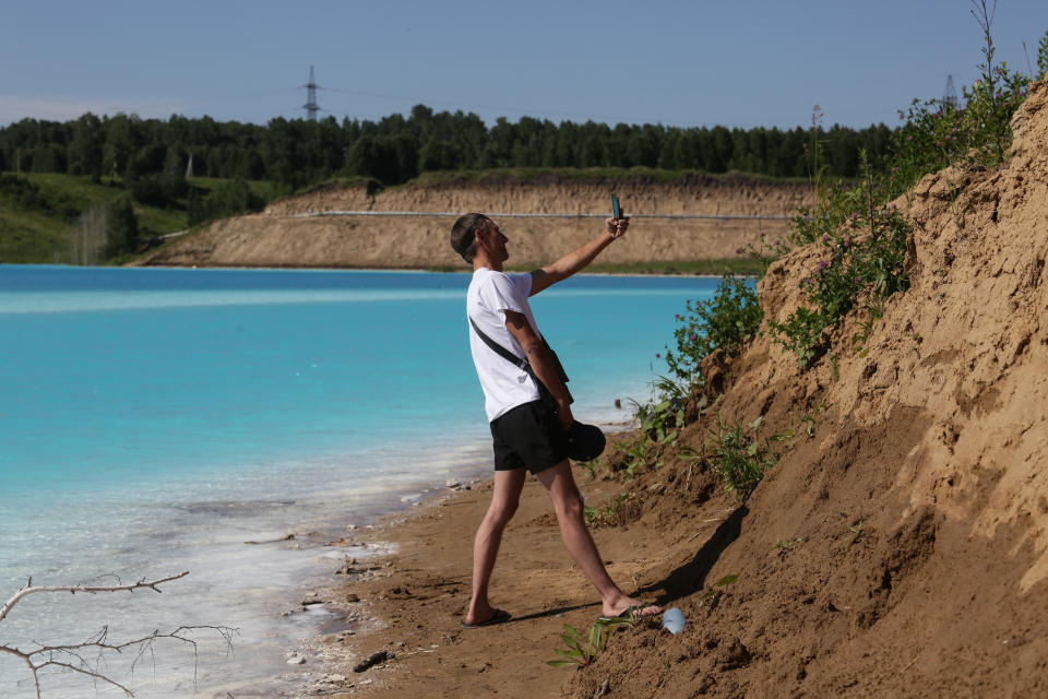 A man takes a selfie picture by a Novosibirsk energy plant's ash dump site - nicknamed the local "Maldives" - on July 11, 2019. (Photo: Rostislav Netisov/AFP/Getty Images)