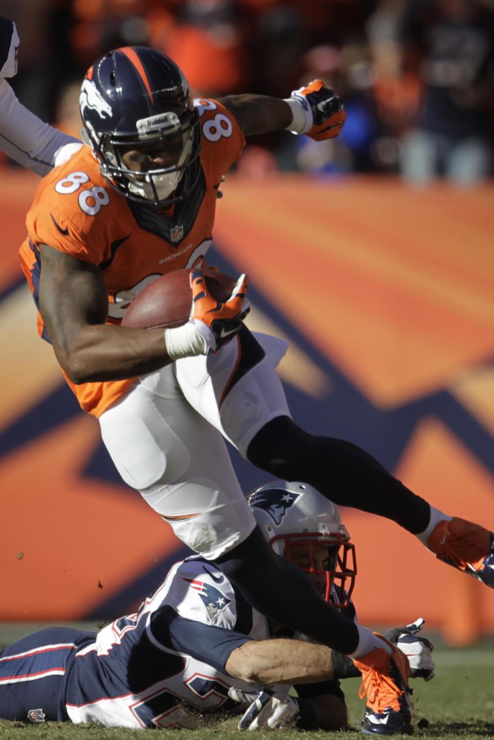 Denver Broncos wide receiver Demaryius Thomas (88) breaks a tackle from New England Patriots strong safety Steve Gregory (28) during the first half of the AFC Championship NFL playoff football game in Denver, Sunday, Jan. 19, 2014. (AP Photo/Joe Mahoney)