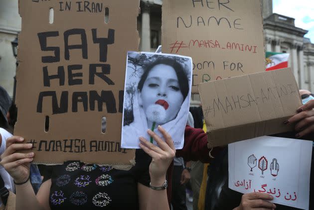 Protesters hold up signs with Amini's name Saturday in London. (Photo: Martin Pope via Getty Images)