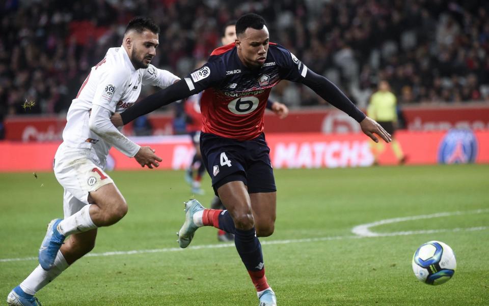 Lille's Brazilian defender Gabriel dos Santos Magalhaes (R) fights for the ball with Montpellier's French forward Gaetan Laborde during the French L1 football match between Lille OSC (LOSC) and Montpellier Herault Sport Club (MHSC) at the Pierre Mauroy Stadium in Villeneuve-d'Ascq, on December 13, 2019. - AFP