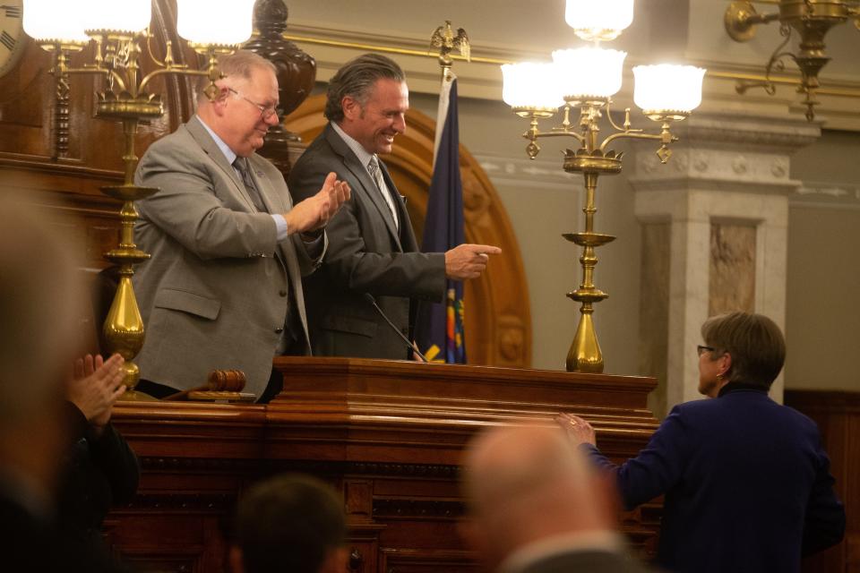 Senate President Ty Masterson, R-Andover, points toward Gov. Laura Kelly as House Speaker Rep. Dan Hawkins, R-Wichita, claps after she concludes her State of the State address Tuesday.