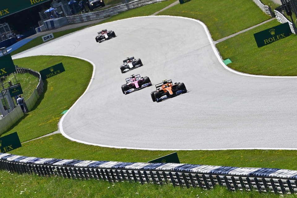 McLaren's British driver Lando Norris (front) and Racing Point's Mexican driver Sergio Perez steer their cars during the Formula One Styrian Grand Prix race on July 12, 2020 in Spielberg, Austria. (Photo by Joe Klamar / various sources / AFP) (Photo by JOE KLAMAR/AFP via Getty Images)