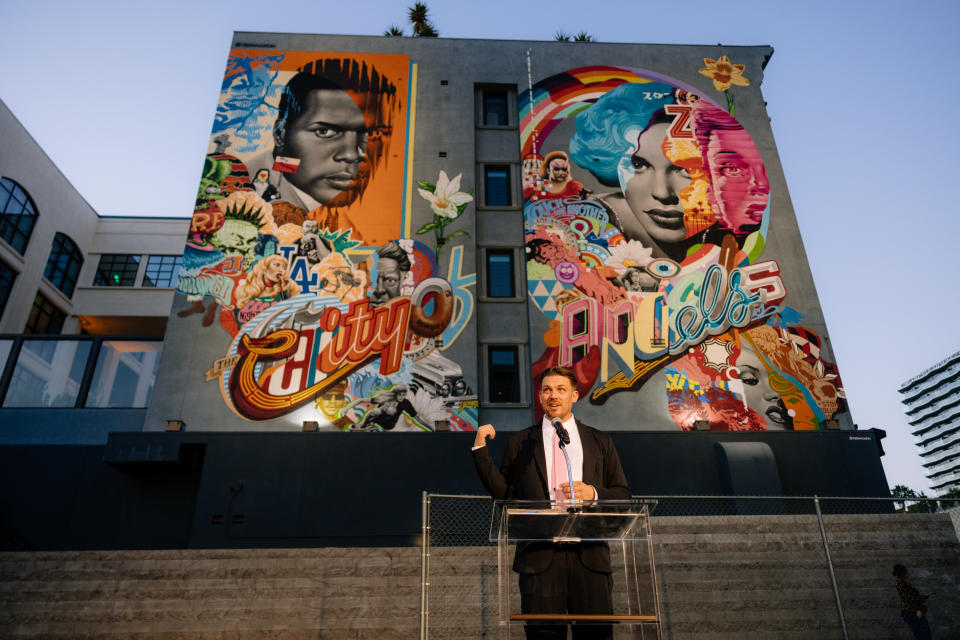 Pop artist Tristan Eaton speaks at the unveiling of his new mural at the Aster club and hotel in Hollywood on Aug. 25, 2022.