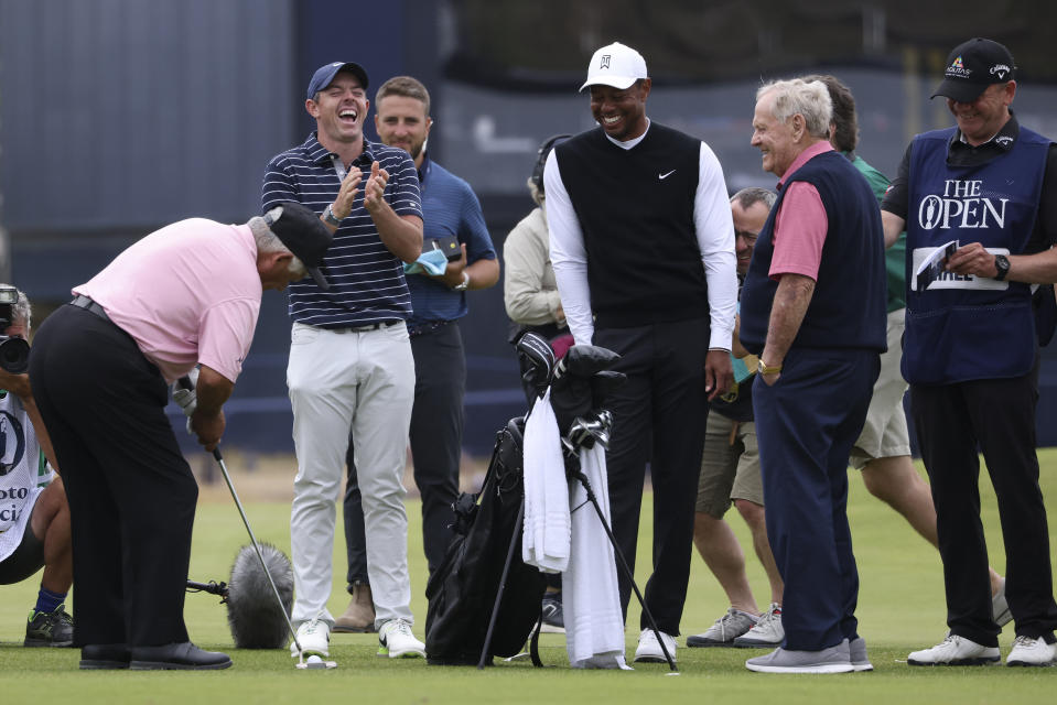 Golf legend Lee Trevino of the United States, left, prepares to play the ball watched by Northern Ireland's Rory McIlroy, Tiger Woods of the US and Jack Nicklaus, from left, during a 'Champions round' as preparations continue for the British Open golf championship on the Old Course at St. Andrews, Scotland, Monday July 11, 2022. The Open Championship returns to the home of golf on July 14-17, 2022, to celebrate the 150th edition of the sport's oldest championship, which dates to 1860 and was first played at St. Andrews in 1873. (AP Photo/Peter Morrison)