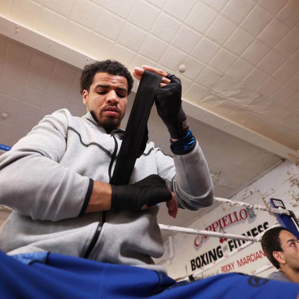 Will Longwe puts on his hand wraps at Cappiello Boxing Gym in Brockton on Thursday, May 2, 2024.