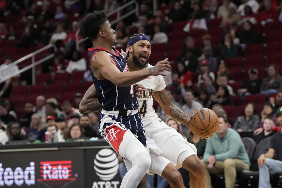 New Orleans Pelicans' Brandon Ingram (14) drives to the basket as Houston Rockets' Jalen Green (4) defends during the second half of an NBA basketball game Friday, March 17, 2023, in Houston. The Rockets won 114-112. (AP Photo/David J. Phillip)