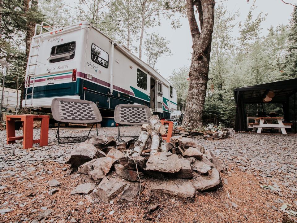 The exterior of Tyler and Todd Gibbon-Thorne's RV with a fire pit out front