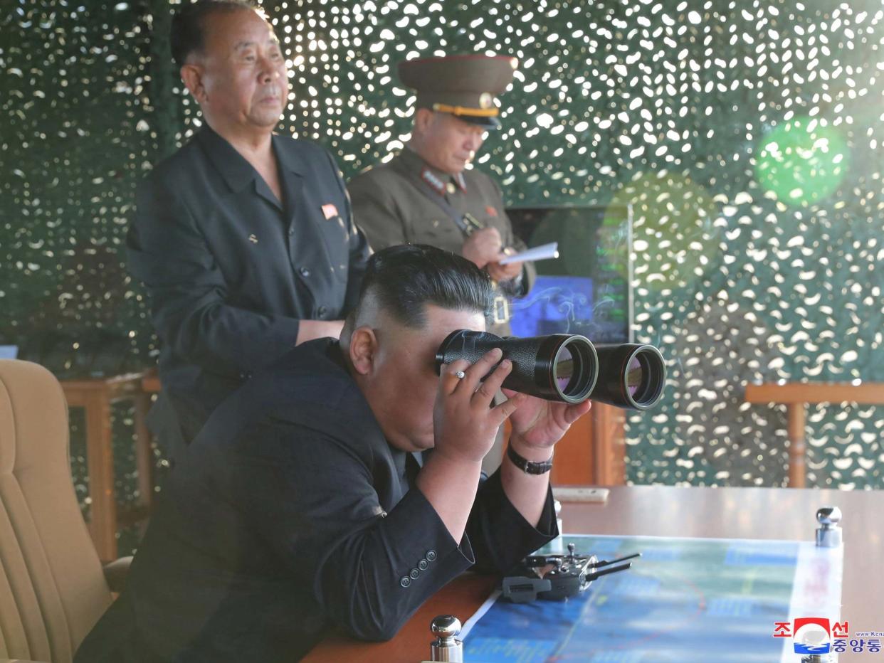 Kim Jong Un pictured watching the test of a multiple rocket launcher, according to state media: KCNA via Reuters