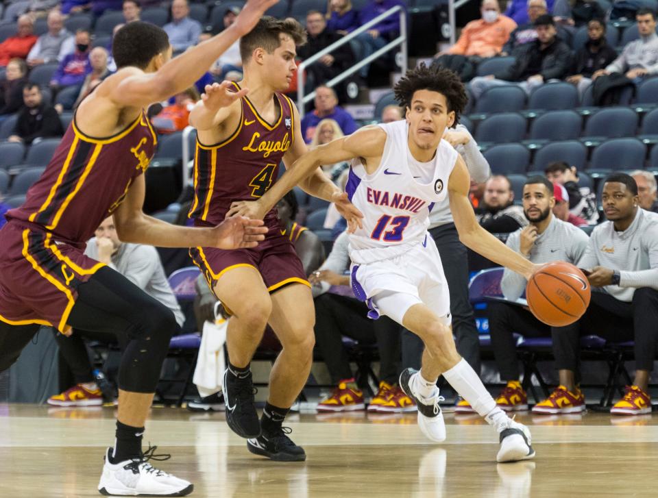 Evansville’s Blaise Beauchamp (13) drives the ball as the University of Evansville Purple Aces play the Loyola Chicago Ramblers at Ford Center in Evansville, Ind., Tuesday evening, Jan. 18, 2022. Loyola Chicago won 77-48.