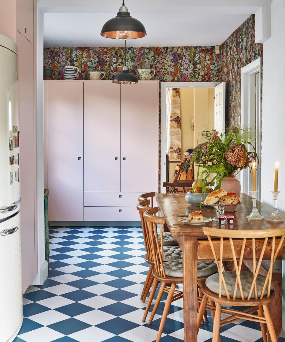 Kitchen wall mural behind pink cabinetry