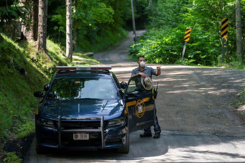 A New York State Trooper stands guard outside the home where attorney Roy Den Hollander was found dead after allegedly killing the son of federal judge Esther Salas and wounding her husband, in Catskills