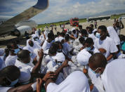 Haitians deported from the United States recover their belongings on the tarmac of the Toussaint Louverture airport in Port-au-Prince, Haiti Tuesday, Sept. 21, 2021 (AP Photo/Joseph Odelyn)