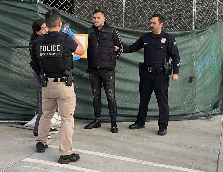 TARZANA CA FEBRUARY 2, 2023 - LAPD and federal officers make an arrested Thursday morning, Feb. 2, 2023 for alleged EBT fraud at a US Bank ATM in Tarzana. Victims had reported their EBT cards had been drained of funds at the ATM near the first of every month. (Rebecca Ellis / Los Angeles Times)