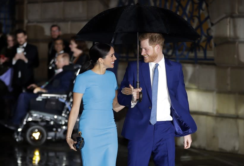 FILE - In this Thursday, March 5, 2020 file photo, Britain's Prince Harry and Meghan, the Duke and Duchess of Sussex arrive at the annual Endeavour Fund Awards in London. Harper Collins U.K. announced Monday, May 4, 2020 that it will publish "Finding Freedom: Harry and Meghan and the Making of a Modern Royal Family" in Britain and the Commonwealth on Aug. 11. The book will be published in the U.S. the same day by Dey Street Books. (AP Photo/Kirsty Wigglesworth, file)