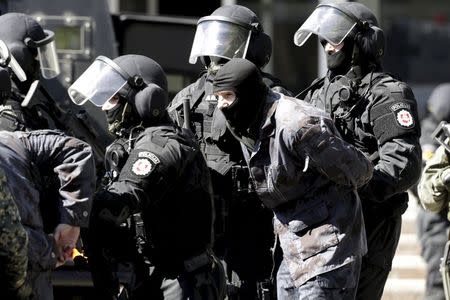 Lithuania's riot police special unit ARAS officers arrest a mock militant during the Zaibo Kirtis (Lightning Strike) joint anti-riot drill in Svencioneliai, Lithuania, in this May 10, 2015 file picture. REUTERS/Ints Kalnins/Files