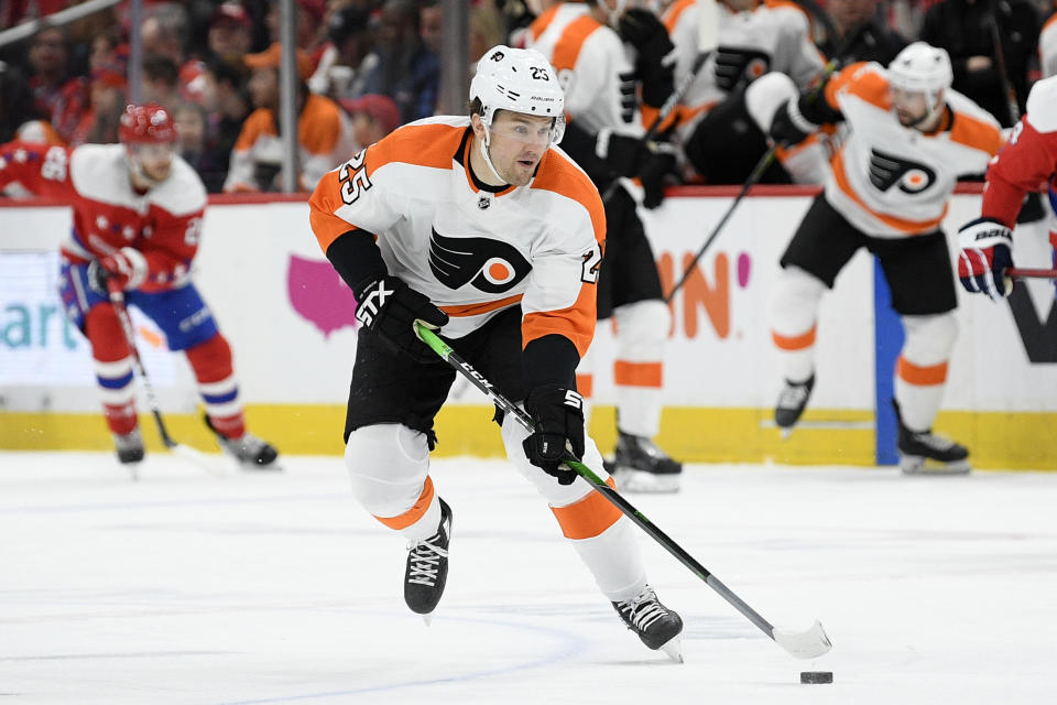 FILE - In this March 4, 2020, file photo, Philadelphia Flyers left wing James van Riemsdyk (25) skates with the puck during the first period of an NHL hockey game against the Washington Capitals in Washington. NHL players are debating the merits of quarantining away from family members as part of a potential resumption of the season. “For sure that’s a big thing,” said van Riemsdyk, one of the players on the Return to Play committee and a new father. “No one wants to be away from their family for months on end, and everyone is aware of that with who’s on this committee." (AP Photo/Nick Wass, File)