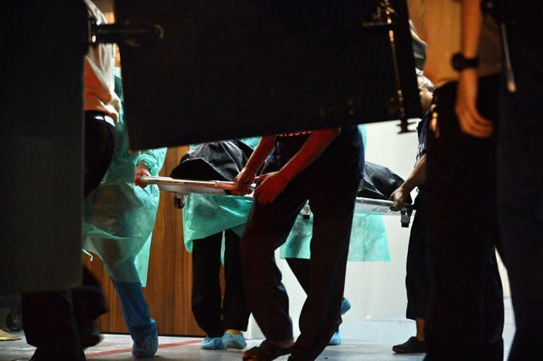 Hospital staff carry the body of the Indian gang-rape victim to the police morgue vehicle at the Mount Elizabeth hospital in Singapore, on December 29, 2012. The victim, 23, died after suffering severe organ failure, the hospital treating her said, in a case that sparked widespread street protests over violence against women