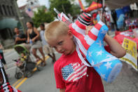 <p>Alexander Depuy, 5, holds an inflatable toy gun at the 19th annual Liberty Festival on July 4, 2012 in Liberty, N.Y. Communities around the country celebrated Independence Day with parades, summer activites and shows of patriotism. (Photo: John Moore/Getty Images) </p>