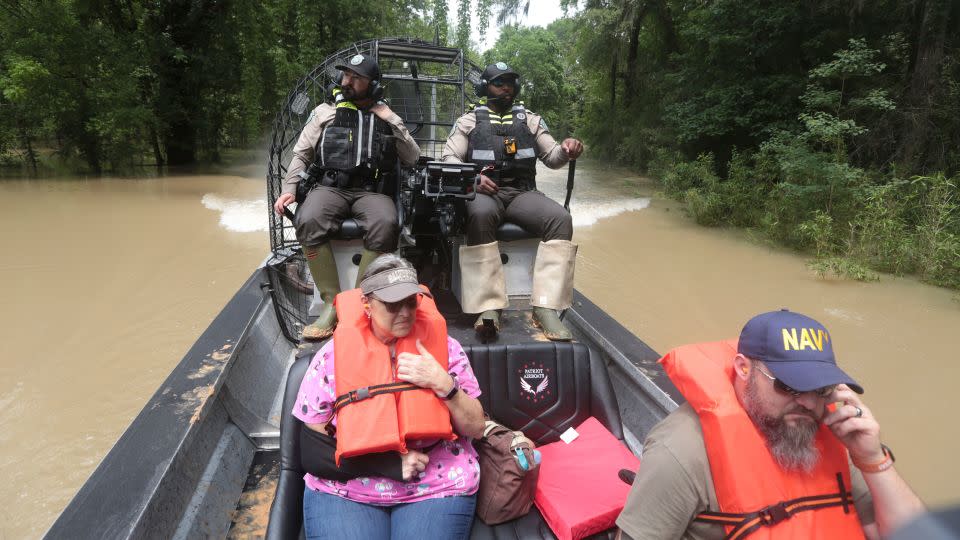 Texas Parks and Wildlife Department officers used boats to rescue residents from floodwaters. - Lekan Oyekanmi/AP