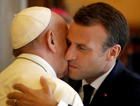 FILE PHOTO: Pope Francis greeets French President Emmanuel Macron during a private audience at the Vatican, June 26, 2018. Alessandra Tarantino/Pool via Reuters/File Photo