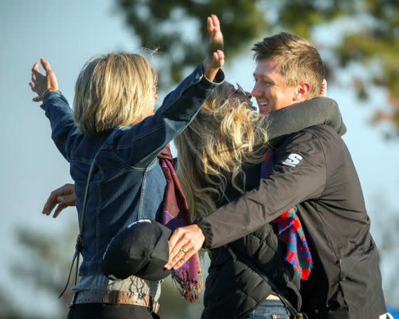 Mackenzie Hughes hugs his wife Jenna and his mother Sandra Hughes, left, after winning RSM Classic in a playoff (AP Photo/Stephen B. Morton).