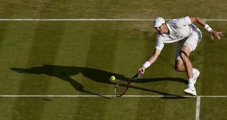 John Isner of the U.S.A. hits the ball during his match against Marin Cilic of Croatia at the Wimbledon Tennis Championships in London, July 3, 2015. REUTERS/Toby Melville