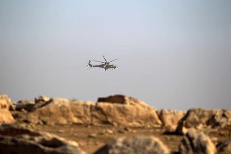 An army military helicopter flies over the Iraqi rapid response forces' position during a battle against Islamic State militants in the south of Mosul, Iraq February 19, 2017. REUTERS/Zohra Bensemra