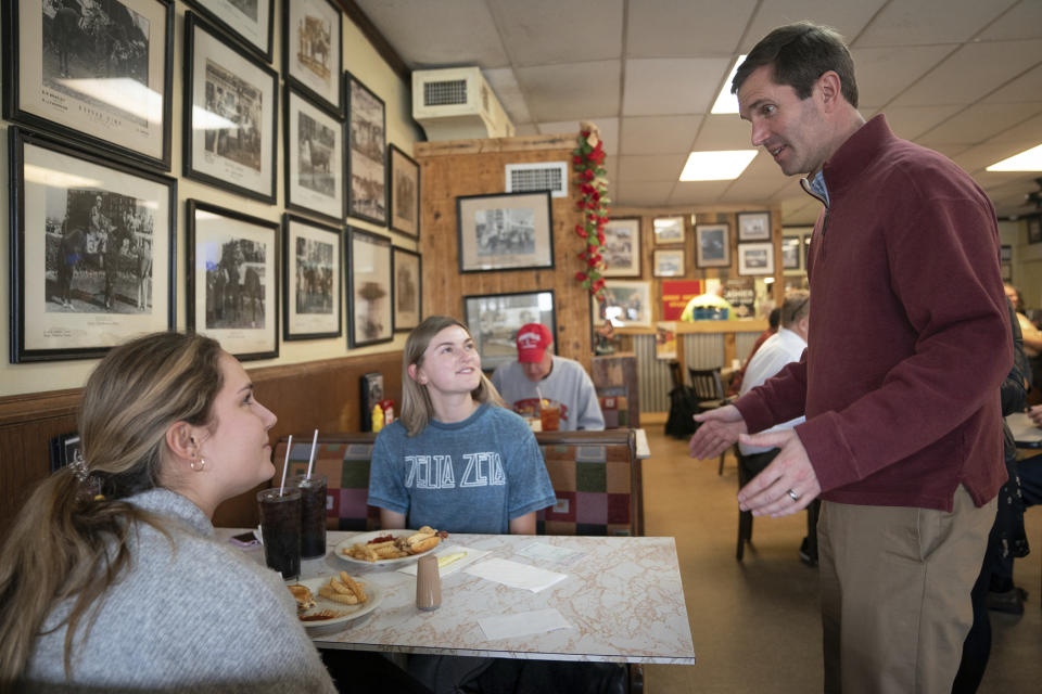 Kentucky Attorney General and Democratic gubernatorial candidate Andy Beshear speaks with voters during a campaign stop at Wagner's Pharmacy, on Election Day, Tuesday, Nov. 5, 2019, in Louisville, Ky. (AP Photo/Bryan Woolston)