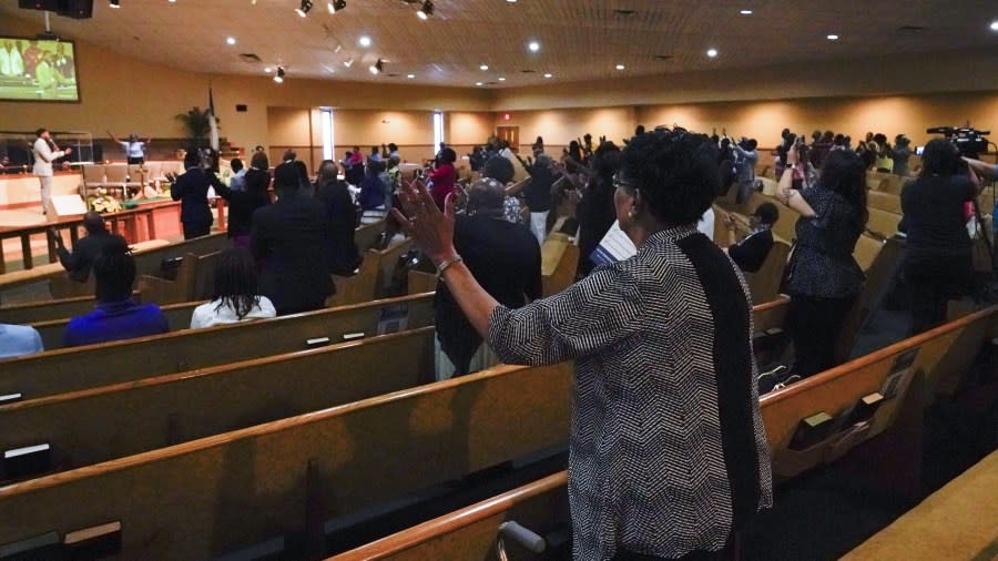 Parishioners pray during a service for the victims of a mass shooting at the St. Paul A.M.E. Church, Sunday, Aug. 27, 2023, in Jacksonville, Fla. (AP Photo/John Raoux)