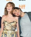 Maya Hawke lends a shoulder to costar Alex Wolff during the <em>Human Capital</em> premiere on Tuesday during the 2019 Toronto International Film Festival.