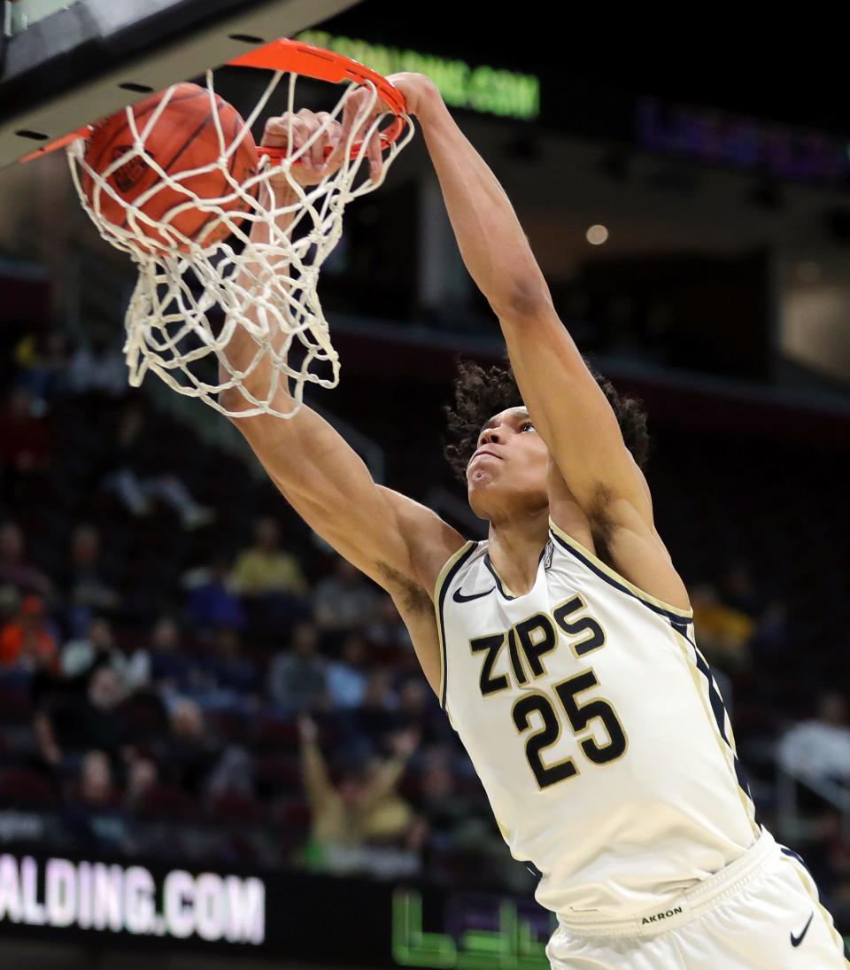 Akron Zips forward Enrique Freeman (25) dunks the ball during the second half of an NCAA college basketball game against the Miami (OH) Redhawks in the quarterfinals of the Mid-American Conference Tournament at Rocket Mortgage FieldHouse, Thursday, March 14, 2024, in Cleveland, Ohio.