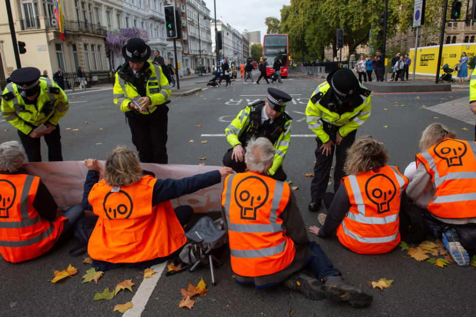 Police arrive on the scene as protestors from Just Stop Oil block the Cromwell road near the Natural History Museum in west London on Oct. 19, 2022 in London, U.K.<span class="copyright">Guy Smallman—Getty Images</span>