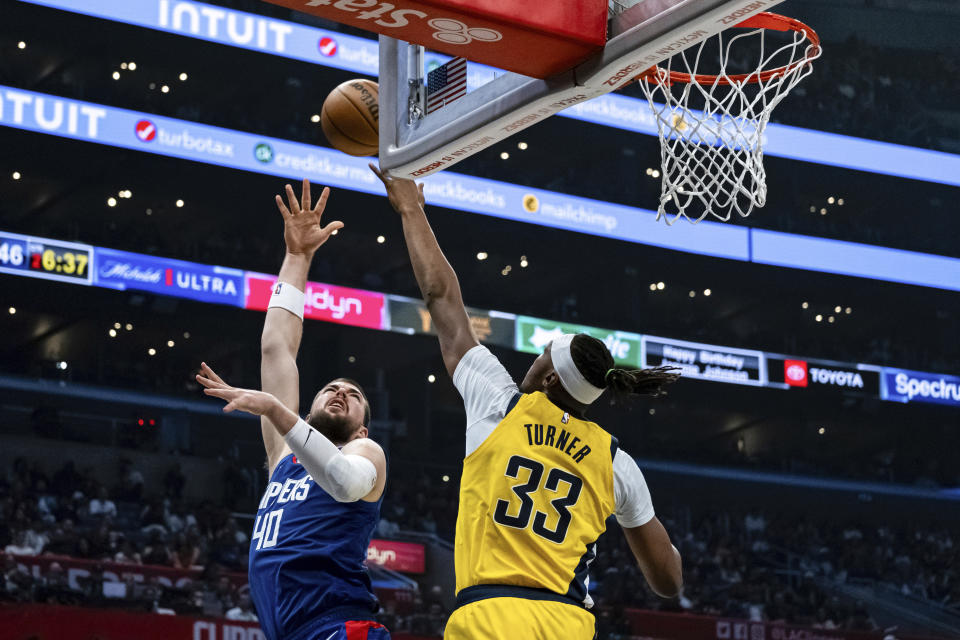Los Angeles Clippers center Ivica Zubac (40) makes a layup against Indiana Pacers center Myles Turner (33) during the first half of an NBA basketball game Monday, March 25, 2024, in Los Angeles. (AP Photo/William Liang)