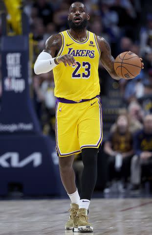 <p>Matthew Stockman/Getty</p> LeBron James plays against the Denver Nuggets