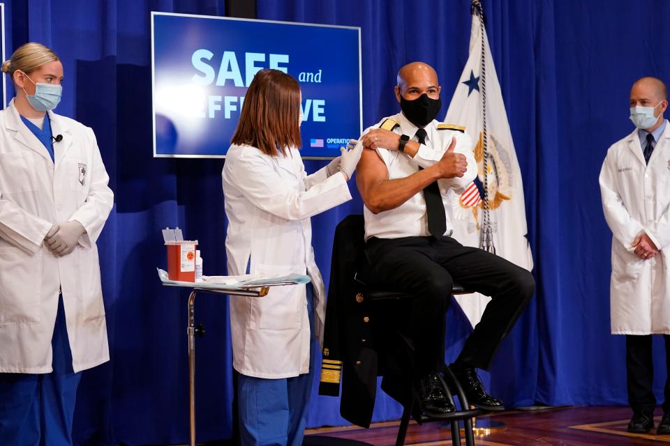 Then-Surgeon General Jerome Adams receives a COVID-19 vaccine on Dec. 18, 2020.