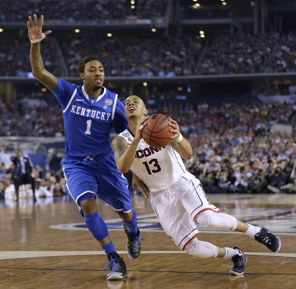 Connecticut guard Shabazz Napier, right, drives past Kentucky guard James Young during the first half of the NCAA Final Four tournament college basketball championship game Monday, April 7, 2014, in Arlington, Texas. (AP Photo/David J. Phillip)