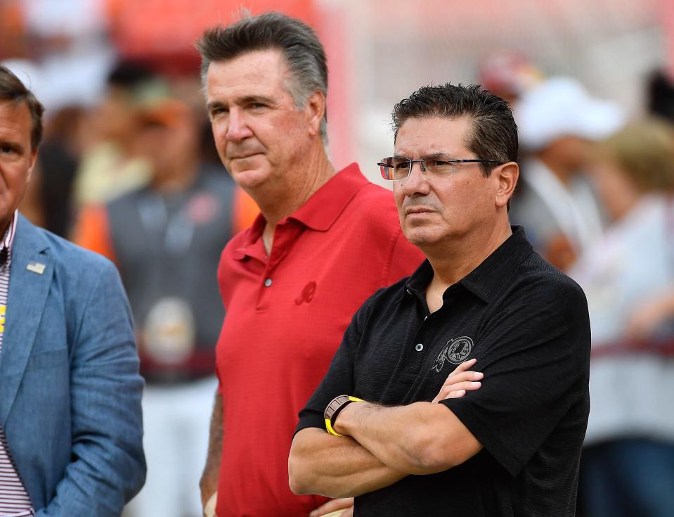 Former Washington Football Team president Bruce Allen (left) and team owner Daniel Snyder (right) on the field before the game against the Cincinnati Bengals at FedEx Field.