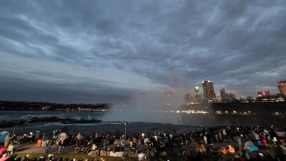 PHOTO: People assemble to view a total solar eclipse, where the moon will blot out the sun, at Niagara Falls, New York, April 8, 2024.  (Brendan Mcdermid/Reuters)