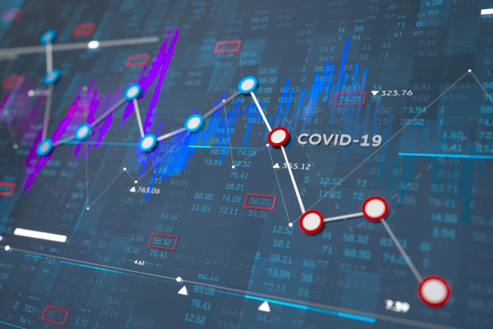 Digital generated image of financial line chart showing fallings because of coronavirus COVID-19 on blue background.