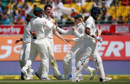 Cricket - India v Australia - Fourth Test cricket match - Himachal Pradesh Cricket Association Stadium, Dharamsala, India - 26/03/17 - Australia's Pat Cummins (C) celebrates with his team-mates after dismissing India's Lokesh Rahul. REUTERS/Adnan Abidi