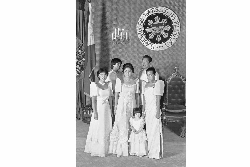 FILE - Philippine President Ferdinand Marcos, back right, and his wife Imelda Marcos, center, pose with their children and a niece, for an official portrait following Marcos inauguration on June 30, 1981, in Manila, Philippines. From left are: Irene, Ferdinand Jr., Mrs. Marcos, Aimee, President Marcos, and Imee. Philippine President Ferdinand Marcos, back right, and his wife Imelda Marcos, center, pose with their children and a niece, for an official portrait following Marcos inauguration, Tuesday, June 30, 1981, Manila, Philippines. From left are: Irene, Ferdinand Jr., Mrs. Marcos, Aimee, President Marcos, and Imee. The son of the late dictator and his running mate Sara, who is the daughter of the outgoing President Rodrigo Duterte, are leading pre-election surveys despite his family's history. (AP Photo/ Jeff Robbins)