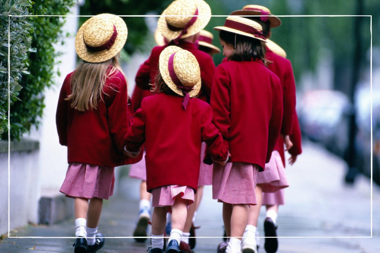  Group of girls in private school uniform, including hats, walking to school. 